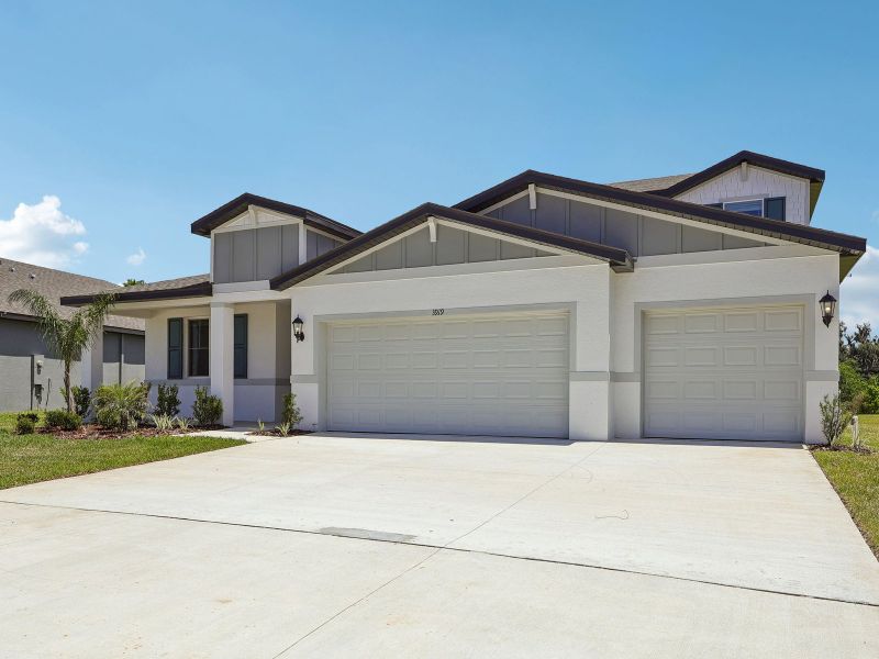 Front exterior of a new home in The Grove at Stuart Crossing - Signature Series, Bartow, FL, highlighting curb appeal (Image 2). Front exterior of a new home in The Grove at Stuart Crossing - Signature Series, Bartow, FL, highlighting curb appeal (Image 2).
