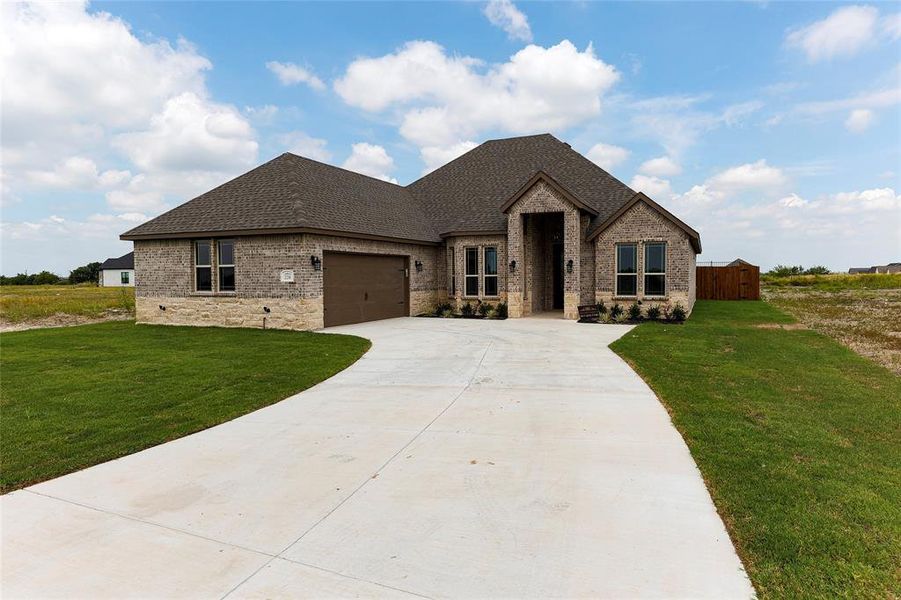 Front exterior of a new home in , Venus, TX, highlighting curb appeal (Image 1).