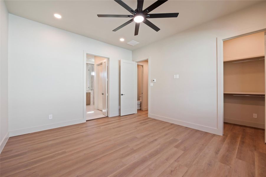 Another view of the Primary showing entry, on-suite bath and walk-in closet