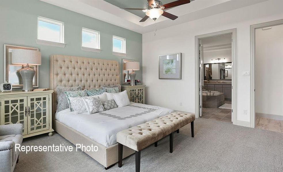 Bedroom featuring ceiling fan, ensuite bathroom, and wood-type flooring