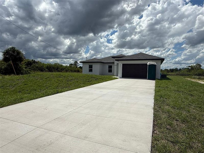 Front exterior of a new home in , Lehigh Acres, FL, highlighting curb appeal (Image 16).