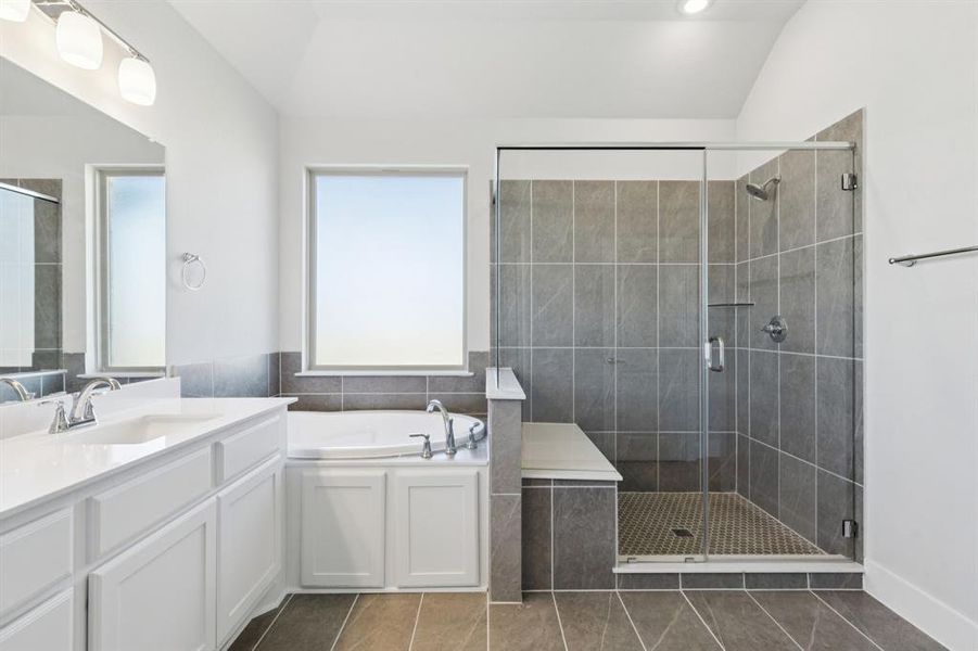 Bathroom with dark tile patterned floors, a garden tub, vanity, a shower stall, and recessed lighting