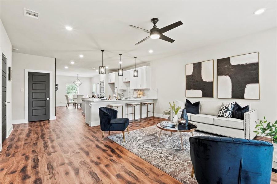 Living room featuring recessed lighting, dark wood-style floors, and ceiling fan Living room featuring recessed lighting, dark wood-style floors, and ceiling fan