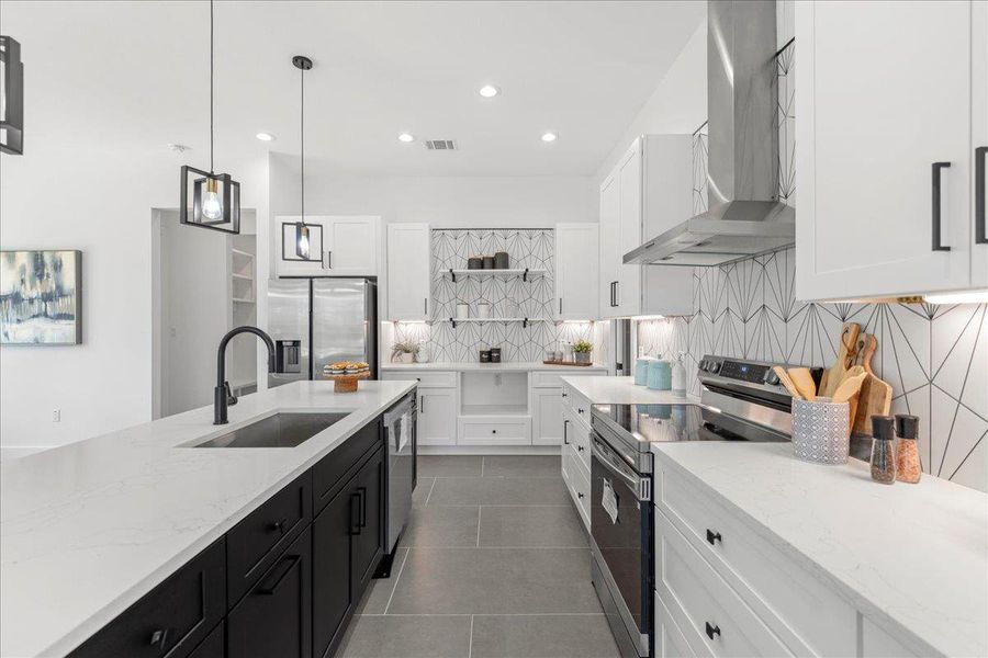 Kitchen with appliances with stainless steel finishes, wall chimney exhaust hood, open shelves, dark cabinetry, and white cabinetry Kitchen with appliances with stainless steel finishes, wall chimney exhaust hood, open shelves, dark cabinetry, and white cabinetry