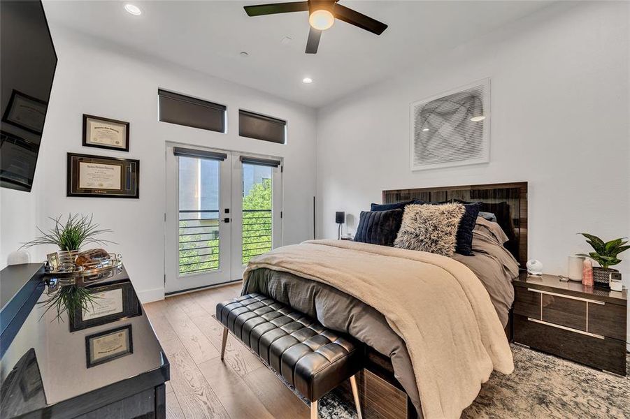 Bedroom featuring access to outside, wood-type flooring, recessed lighting, and a ceiling fan Bedroom featuring access to outside, wood-type flooring, recessed lighting, and a ceiling fan