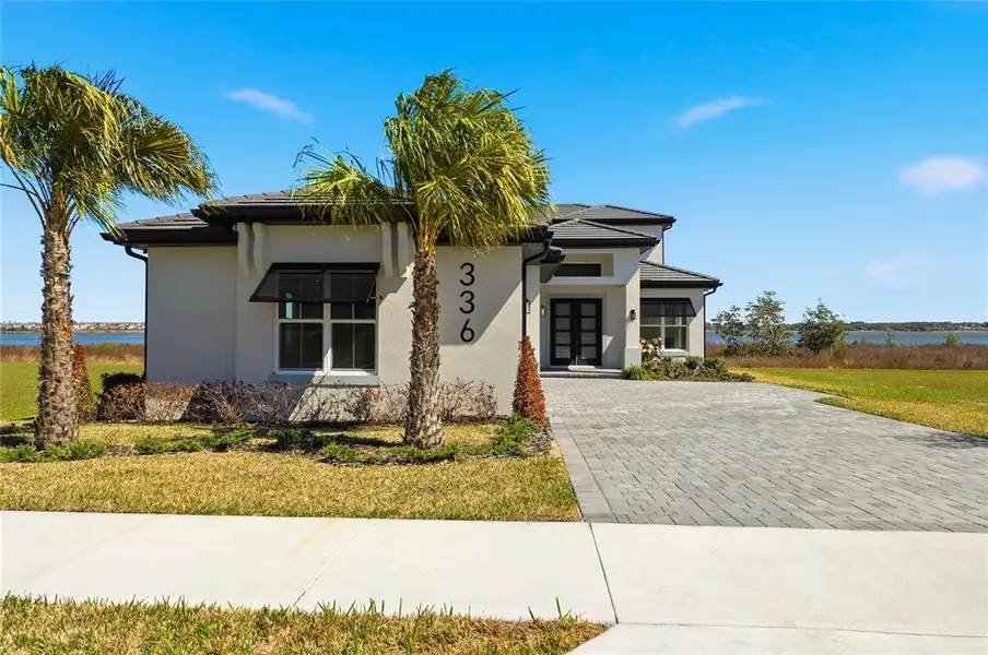 Front exterior of a new home in , Lake Alfred, FL, highlighting curb appeal (Image 1). Front exterior of a new home in , Lake Alfred, FL, highlighting curb appeal (Image 1).