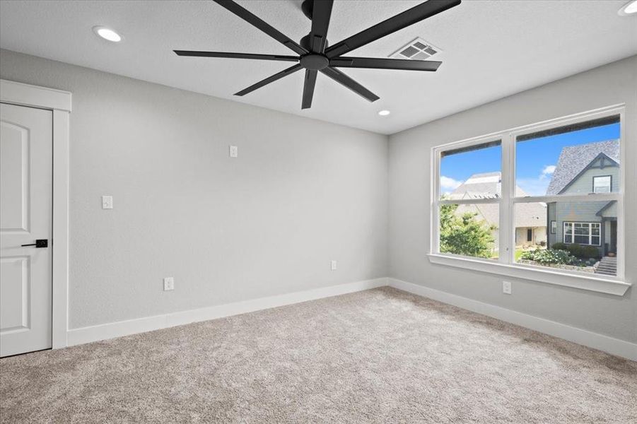 Carpeted spare room with a ceiling fan and recessed lighting