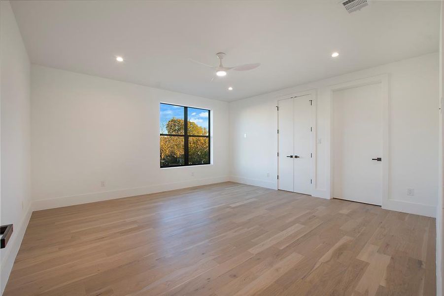 Unfurnished bedroom featuring ceiling fan and light wood-type flooring