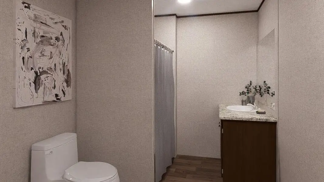 Bathroom featuring a white toilet, wood-finish flooring, a single vanity with a white countertop, and a shower with a privacy curtain Bathroom featuring a white toilet, wood-finish flooring, a single vanity with a white countertop, and a shower with a privacy curtain