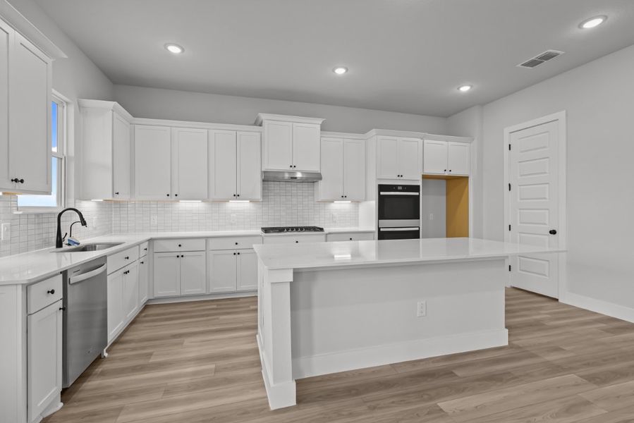 A kitchen with white cabinets. A kitchen with white cabinets.