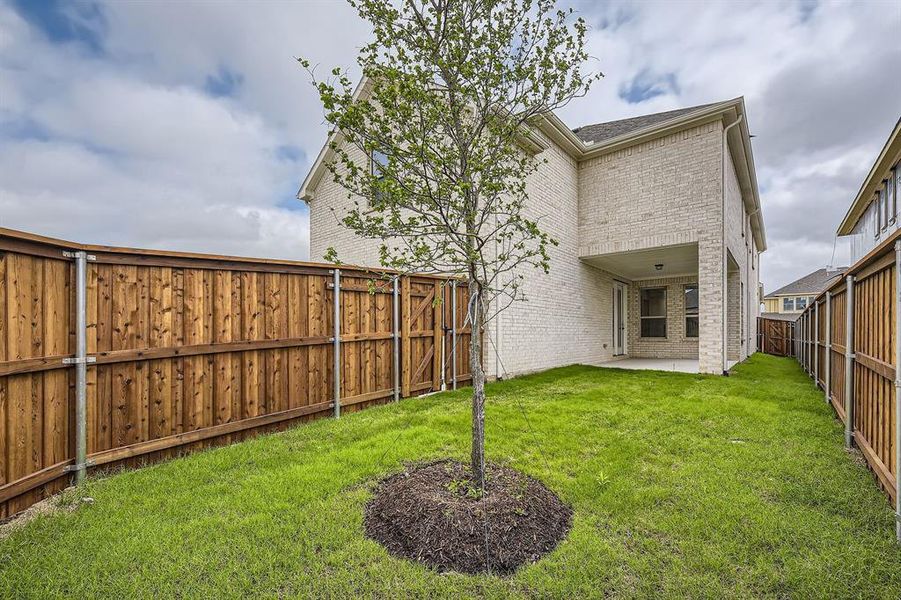 Rear view of house featuring brick siding, a patio, a fenced backyard, and roof with shingles Rear view of house featuring brick siding, a patio, a fenced backyard, and roof with shingles