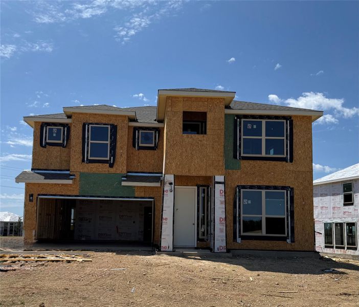 View of front of home with driveway, stucco siding, and a garage View of front of home with driveway, stucco siding, and a garage