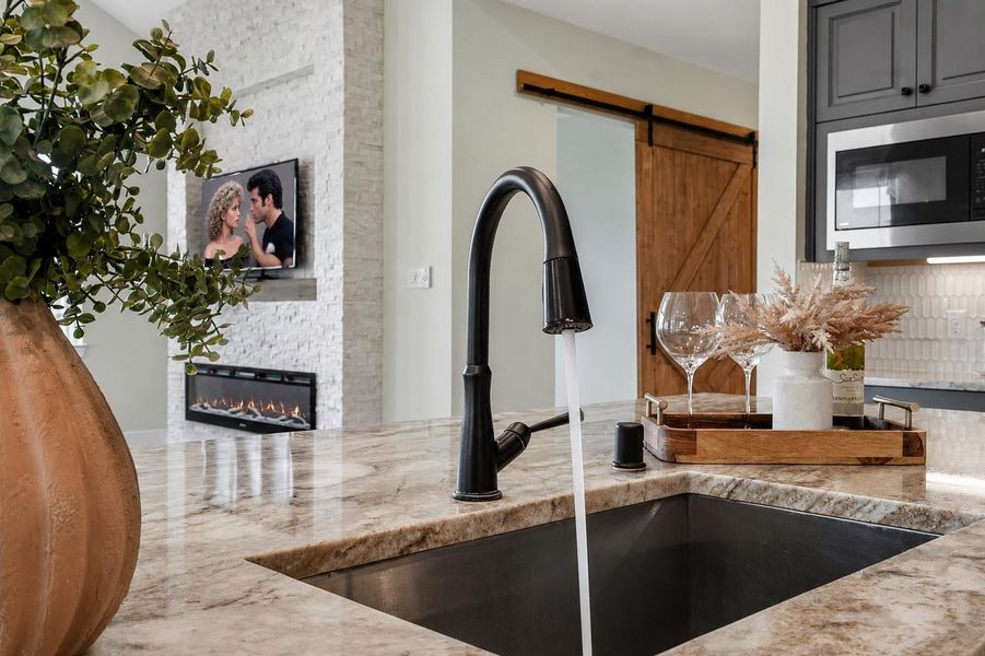 The Kitchen Island is as functional as it is stylish, featuring an undermount stainless steel sink with a convenient pull-down faucet. Together, the high-quality appliances and finishes enhance the Kitchen’s functionality while complementing its polished, upscale design.