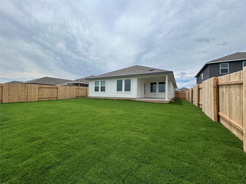 Rear view of house with a fenced backyard Rear view of house with a fenced backyard