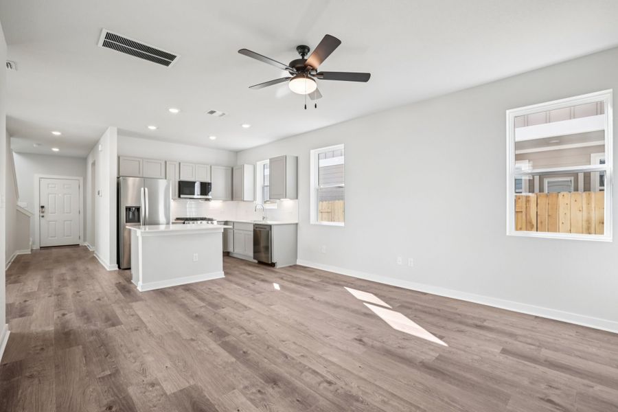 A kitchen with white cabinets.