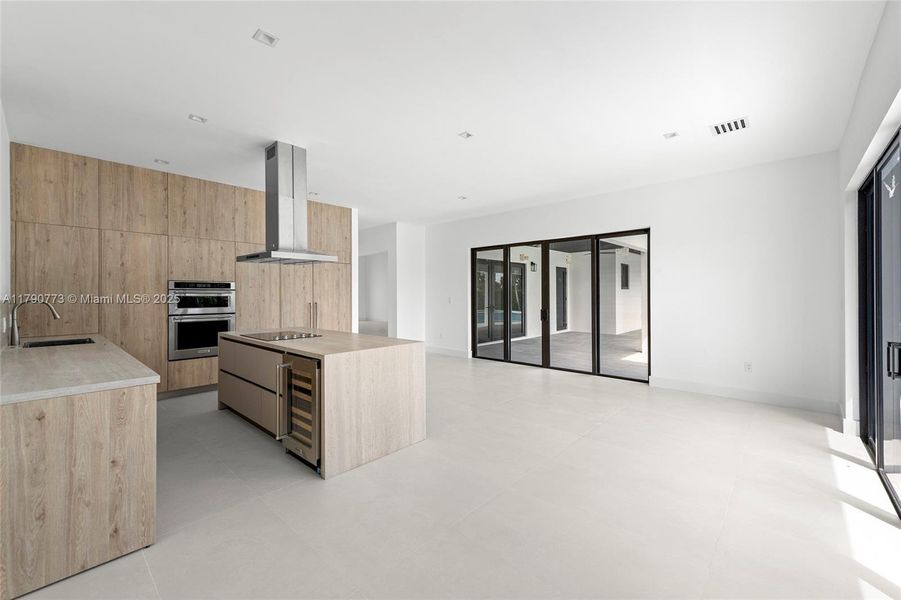 The heart of the home boasts a chef-inspired kitchen with a fully integrated, 48-inch panel-ready JennAir refrigerator, merging top-tier functionality with refined, modern aesthetics. The heart of the home boasts a chef-inspired kitchen with a fully integrated, 48-inch panel-ready JennAir refrigerator, merging top-tier functionality with refined, modern aesthetics.