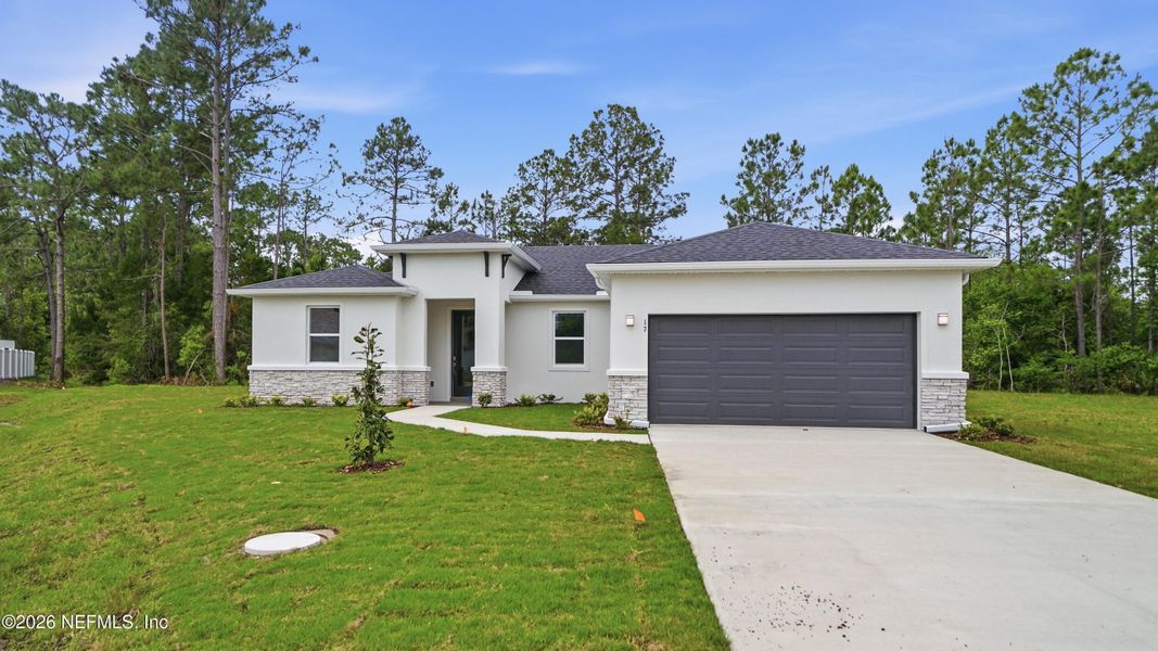 Front exterior of a new home in Palm Coast, Palm Coast, FL, highlighting curb appeal (Image 25).