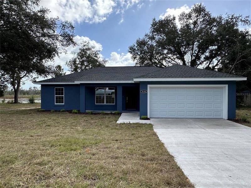 Front exterior of a new home in , Ocklawaha, FL, highlighting curb appeal (Image 1).