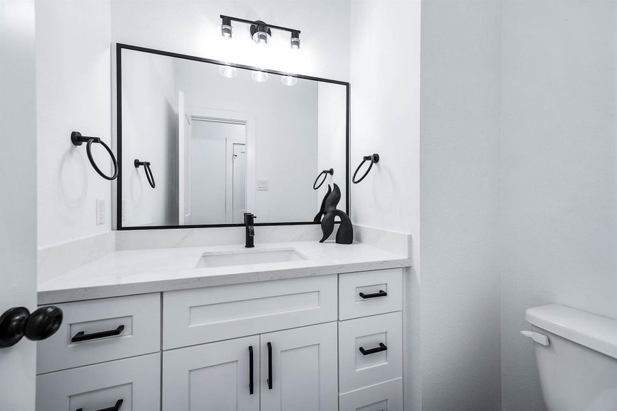 Stylish bathroom vanity with modern fixtures, sleek hardware, and a large mirror that enhances the bright and polished look.