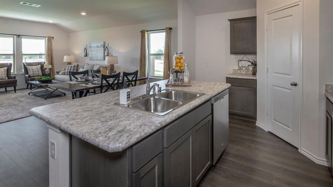 Kitchen with open floor plan, light countertops, plenty of natural light, vaulted ceiling, and recessed lighting