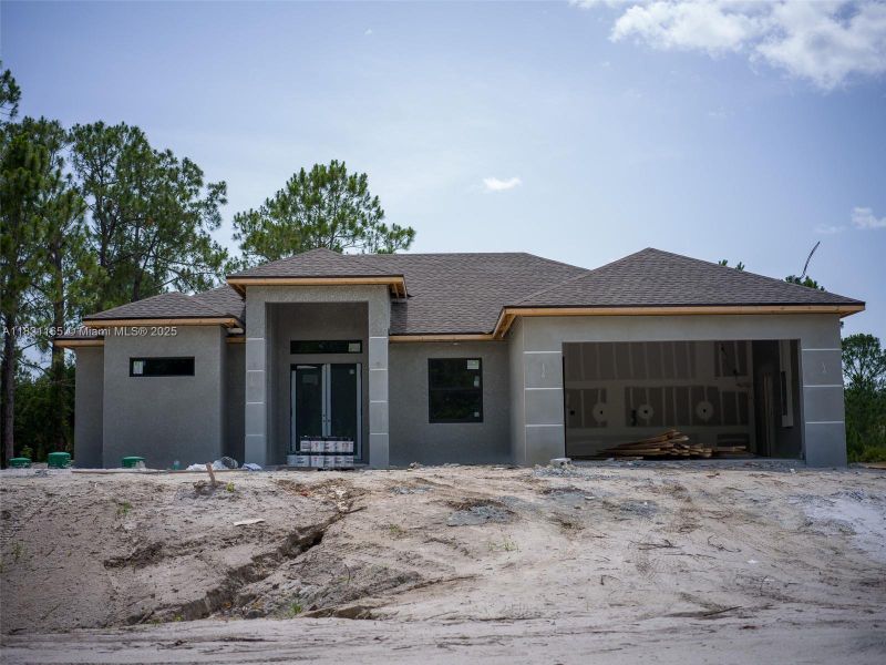 Front exterior of a new home in , Lehigh Acres, FL, highlighting curb appeal (Image 2).