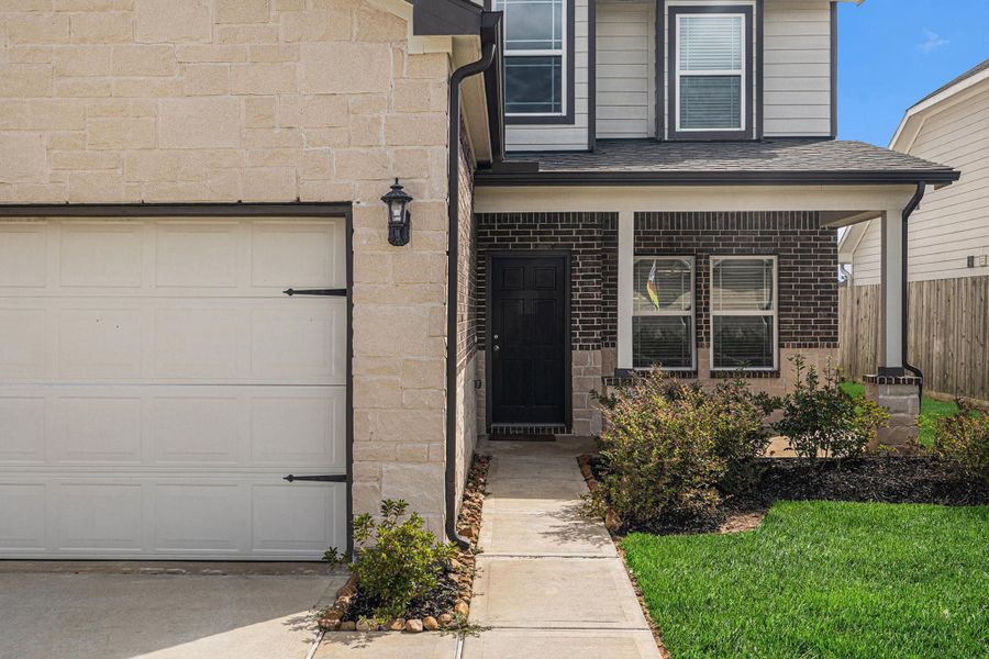 Front exterior of a new home in Grand Oaks Reserve, Cleveland, TX, highlighting curb appeal (Image 1).