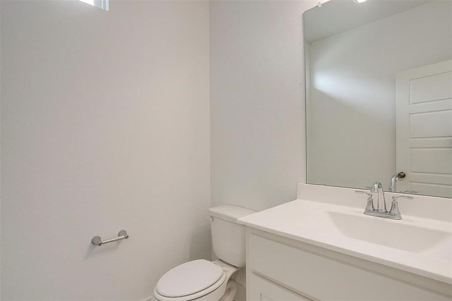 Bathroom featuring oversized vanity and toilet