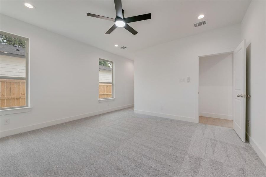 Empty room with light colored carpet, recessed lighting, and ceiling fan Empty room with light colored carpet, recessed lighting, and ceiling fan