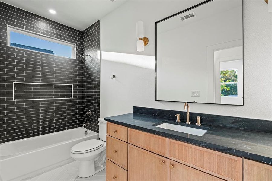 Full bath with plenty of natural light, vanity, bathtub / shower combination, and tile patterned floors