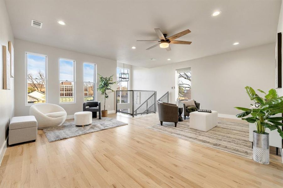 Living area featuring ceiling fan and light hardwood / wood-style flooring