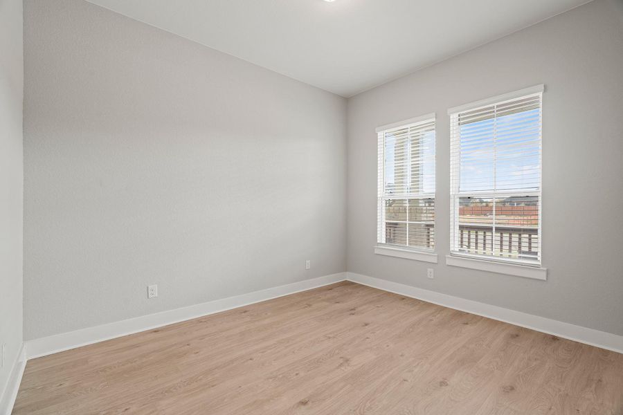 Empty room with light wood-style floors and baseboards Empty room with light wood-style floors and baseboards