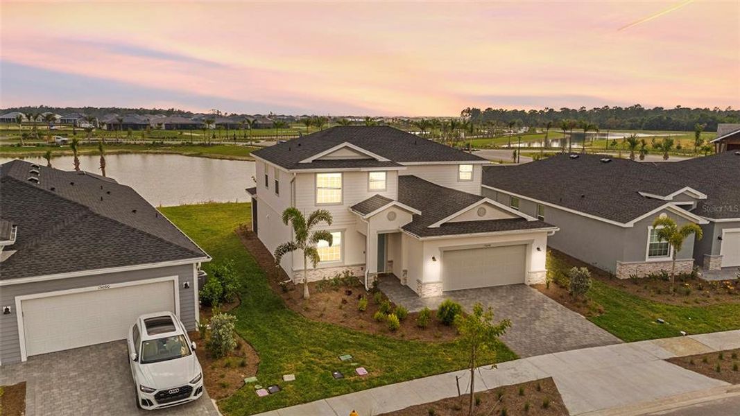 Front exterior of a new home in Tuckers Cove: Villas, Punta Gorda, FL, highlighting curb appeal (Image 27).