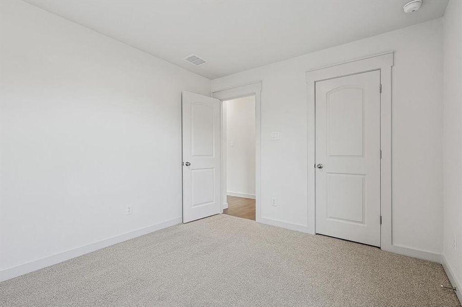 Unfurnished bedroom featuring carpet floors and baseboards Unfurnished bedroom featuring carpet floors and baseboards