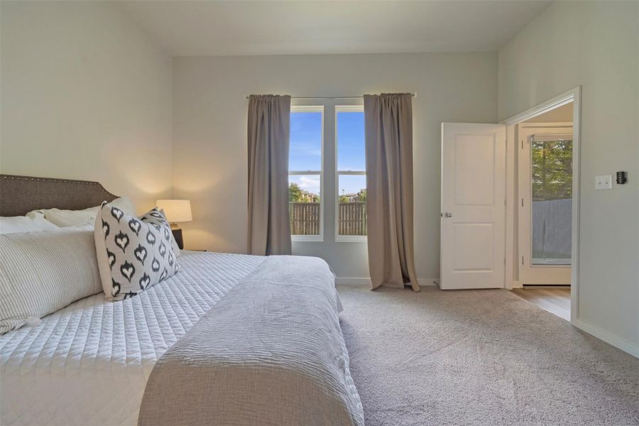 Large primary bedroom with beautiful drapes