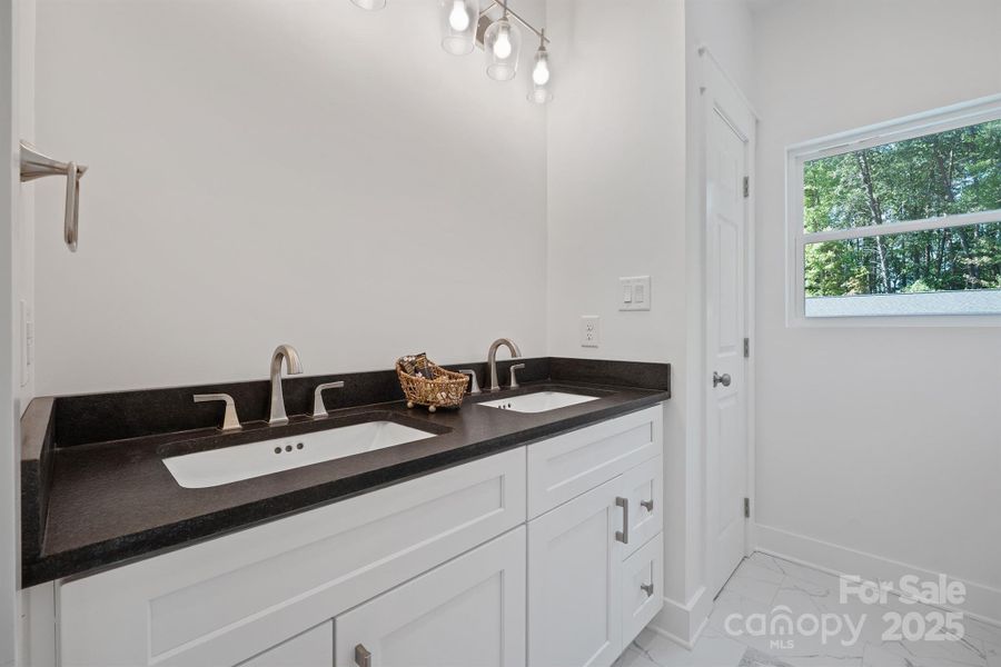 Primary bath with double sinks and leathered granite
