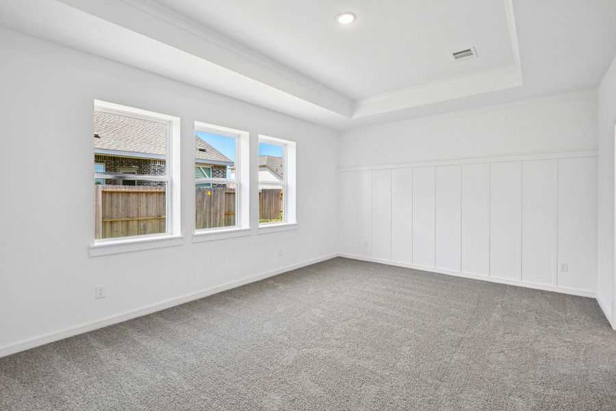 Tranquil primary suite with feature wall