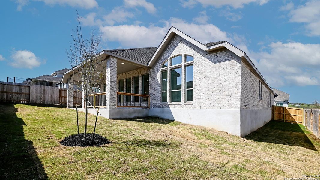 Front exterior of a new home in Homestead 65', Schertz, TX, highlighting curb appeal (Image 1).