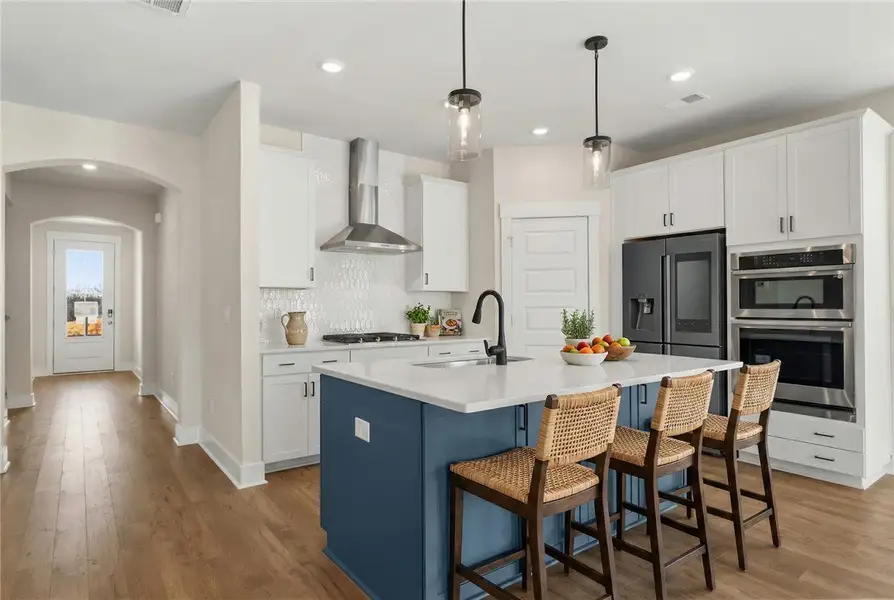 This bright kitchen features an expansive island a