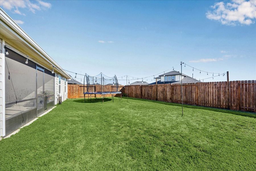 Plenty of room in this large backyard for all of your desires with play equipment, or even a pool.