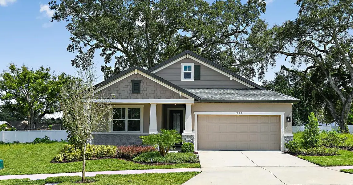Front exterior of a new home in Tamarack at Two Rivers, Zephyrhills, FL, highlighting curb appeal (Image 2). Front exterior of a new home in Tamarack at Two Rivers, Zephyrhills, FL, highlighting curb appeal (Image 2).