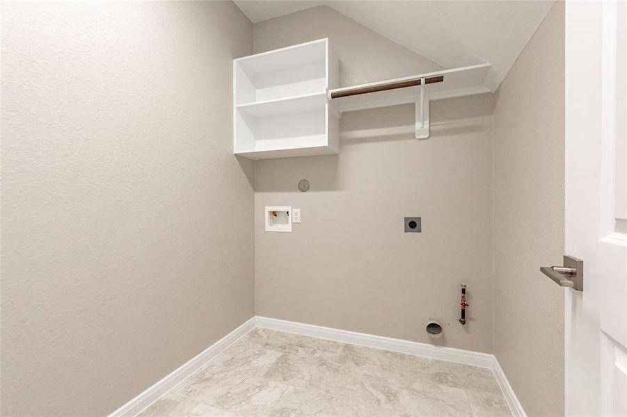 Large utility room with shelving and gas/electric dryer connections