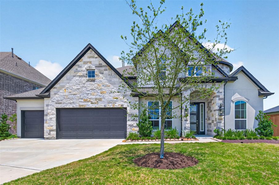 Front exterior of a new home in Towne Lake 70’, Cypress, TX, highlighting curb appeal (Image 1). Front exterior of a new home in Towne Lake 70’, Cypress, TX, highlighting curb appeal (Image 1).