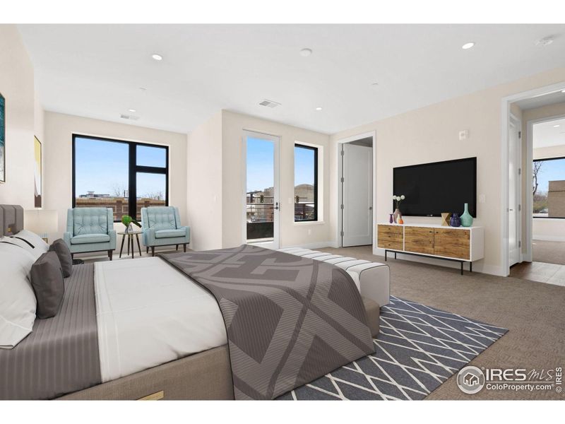 The largest of the primary bedrooms in the building, including a his and her closet, and a reading nook, which was the original building's elevator shaft. This photo has been virtually staged.