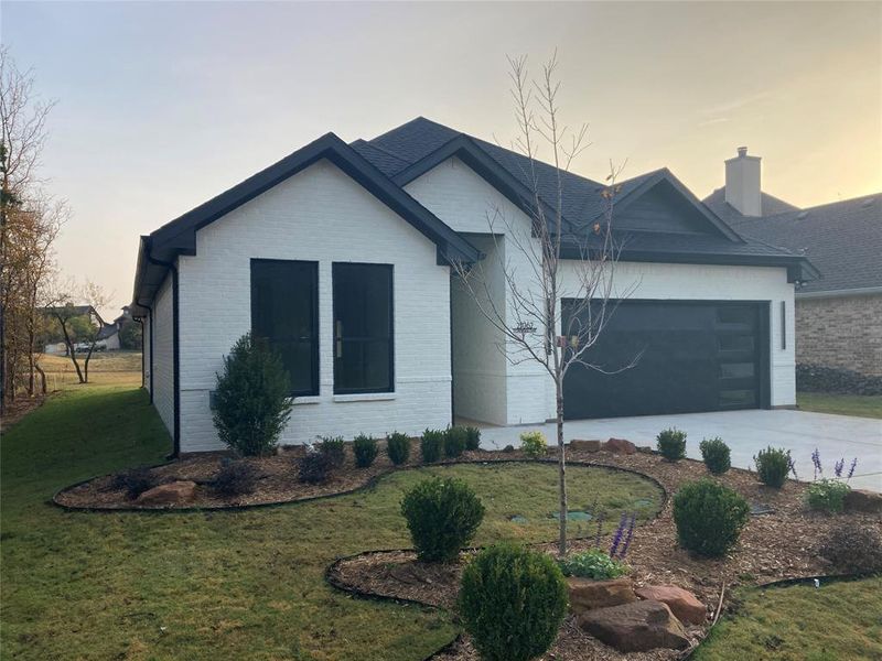 Front exterior of a new home in , Whitney, TX, highlighting curb appeal (Image 18). Front exterior of a new home in , Whitney, TX, highlighting curb appeal (Image 18).