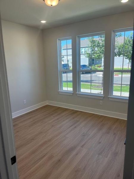 Spare room with dark wood-style flooring and recessed lighting Spare room with dark wood-style flooring and recessed lighting
