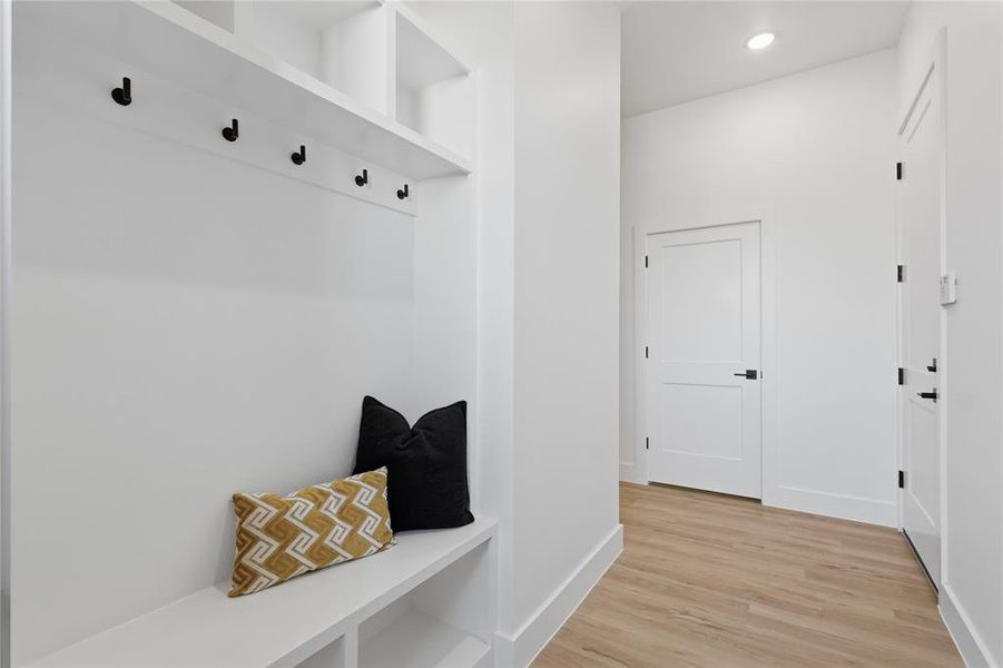 Mudroom featuring light wood-type flooring and recessed lighting