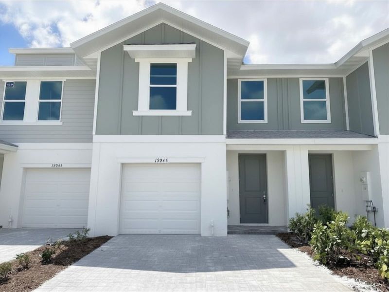 Front exterior of a new home in Meritage Homes at Central Park, Port St. Lucie, FL, highlighting curb appeal (Image 1). Front exterior of a new home in Meritage Homes at Central Park, Port St. Lucie, FL, highlighting curb appeal (Image 1).