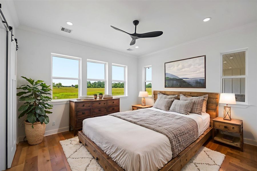 Spacious and inviting primary bedroom with abundant natural light, showcasing elegant furnishings and serene views. Perfect for relaxation and comfort. DIGITALLY STAGED