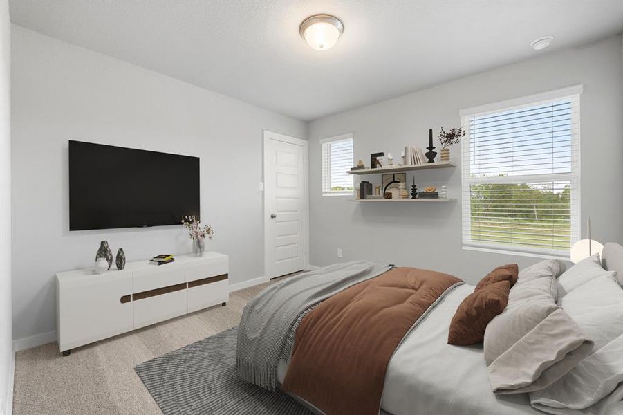 Secondary bedroom features plush carpet, neutral paint, large window and ample closet space.