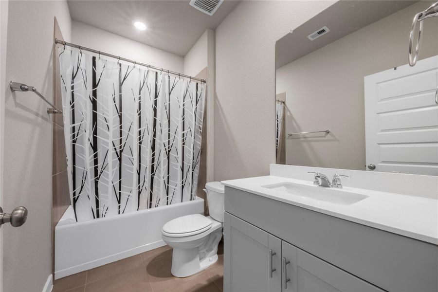 Well-appointed primary bathroom featuring a spacious layout with modern fixtures, ample counter space, and a clean, functional design for everyday convenience.